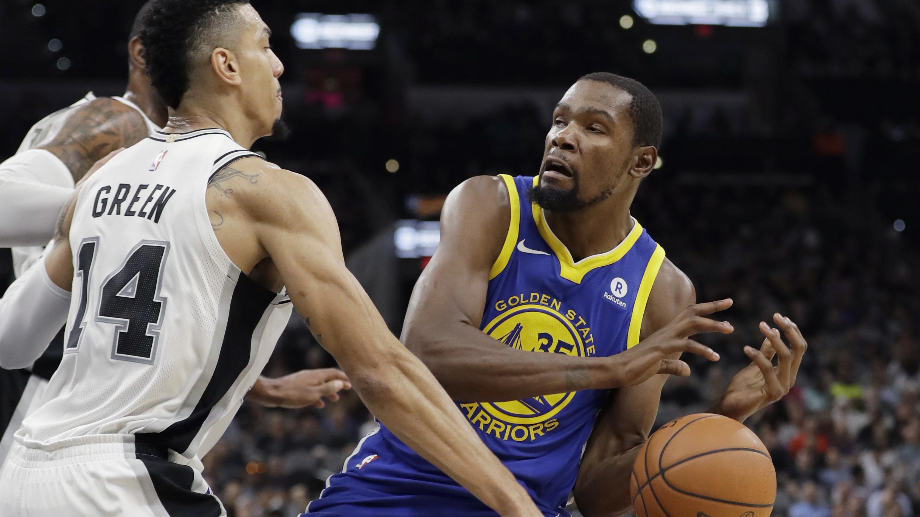 Kevin Durant (35) mencoba melewati adangan pemain San Antonio Spurs, Danny Green  pada laga NBA basketball game di AT&T Center, San Antonio, (2/11/2017) waktu setempat. Warriors menang 112-92. (AP/Eric Gay)
