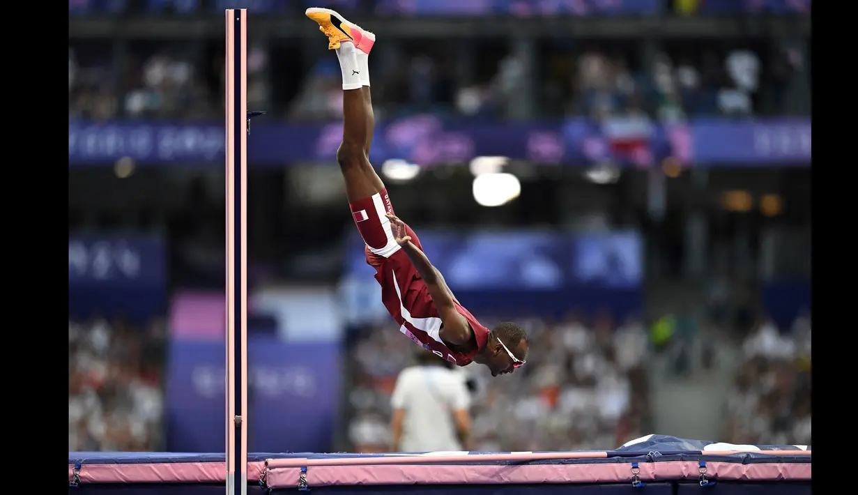 Atlet Qatar, Mutaz Barshim saat berkompetisi dalam pertandingan final cabang olahraga lompat tinggi Olimpiade Paris 2024 di Stade de France, Paris, Prancis, Sabtu (10/08/2024) waktu setempat. Ia berhasil mendapatkan medali perunggu dengan lompatan setinggi 2,34 meter. (AFP/Ben Stansall)