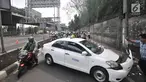 Pengendara sepeda motor tersendat saat melintasi lokasi kecelakaan taksi menabrak tiang di Jalan Ahmad Yani, Jakarta, Rabu (1/8). Kecelakaan terjadi setelah sopir taksi berusaha menghindari pengendara sepeda motor di depannya. (Merdeka.com/Iqbal Nugroho)
