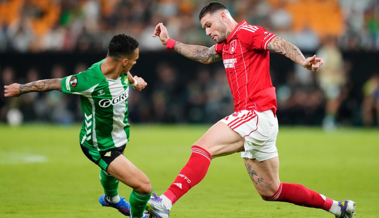 Pemain Real Betis, Antony, berebut bola dengan pemain Nottingham Forest, Morato, pada laga perdana fase grup Liga Europa 2025/2026 di Stadion La Cartuja, Kamis (25/9) dini hari WIB. (AP Photo/Jose Breton)