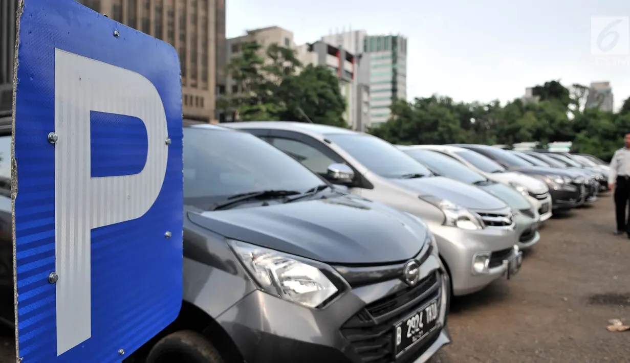 Petugas Dishub DKI memeriksa mobil yang terparkir di Park and Ride kawasan MH Thamrin, Jakarta, Kamis (6/12). Kenaikan tarif parkir akan mulai pertama kali diterapkan di IRTI Monas dan sejumlah kantong parkir milik Pemprov DKI. (Merdeka.com/Iqbal Nugroho)