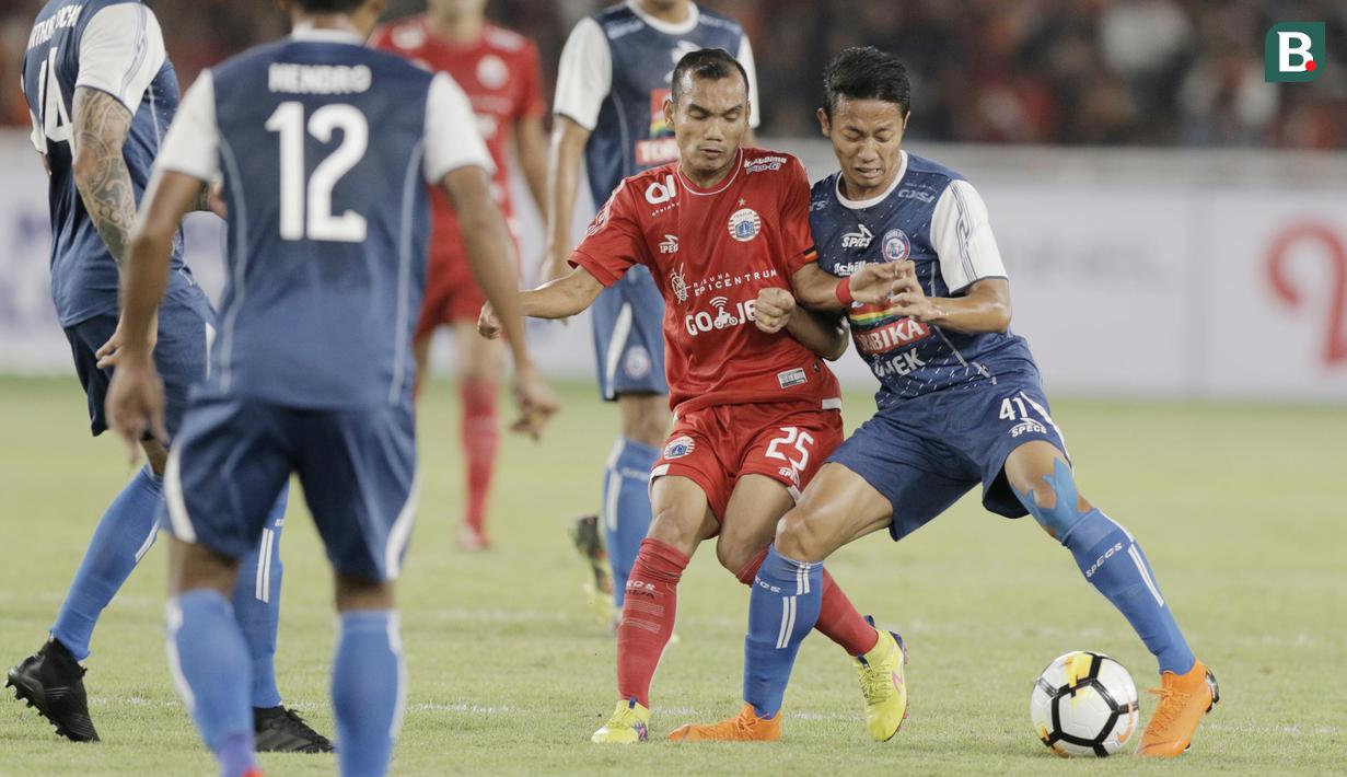 Gelandang Persija Jakarta, Riko Simanjuntak, berebut bola dengan striker Arema FC, Dendi Santoso, pada laga Liga 1 di SUGBK, Jakarta, Sabtu (31/3/2018). Persija menang 3-1 atas Arema FC. (Bola.com/M Iqbal Ichsan)