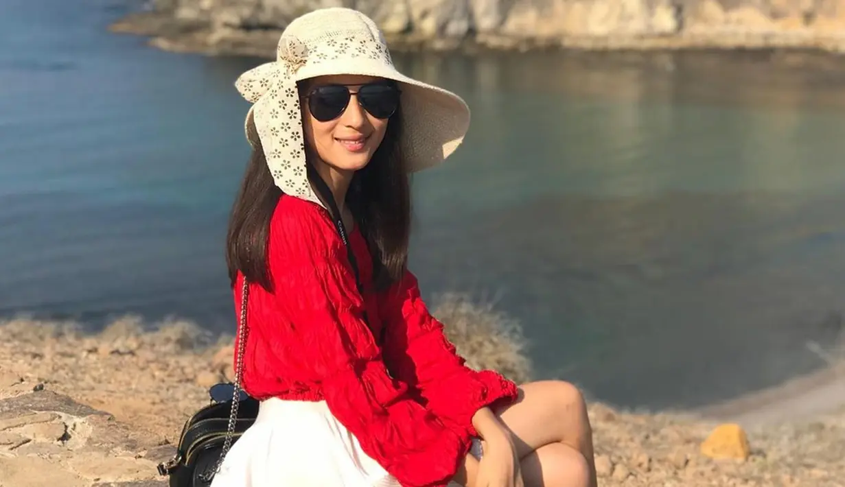 Begitu pula saat dirinya berlibur ke Pulau Padar di Labuan Bajo. Shanna memakai atasan merah berlengan panjang dan rok mini berwarna putih. Tak lupa, ia juga memakai aksesori seperti topi bundar dan kacamata hitam untuk menghalau teriknya sinar matahari. (Liputan6.com/IG/shannashannonsiswanto)