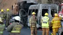 Petugas pemadam kebakaran dan forensik berada di lokasi kecelakaan antara sebuah van dan truk kargo  di jalan raya Negara Bagian Jalisco, Meksiko, Rabu (18/12/2019). (Ulises Ruiz / AFP)