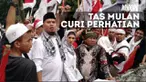 Tampil berhijab, Mulan Jameela ikut serta menemani Ahmad Dhani berdemo sambil menenteng tas mahal.
