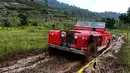 Mobil Land Rover menerobos jalan berlumpur pada acara kamping bersama di kaki gunung Gede Pangrango, Bogor, Jawa Barat, Minggu (23/12). Acara yang digelar selama 3 hari diikuti sekitar 800 mobil se Indonesia dan luar negeri. (Liputan6.com/Pool/ILRU)
