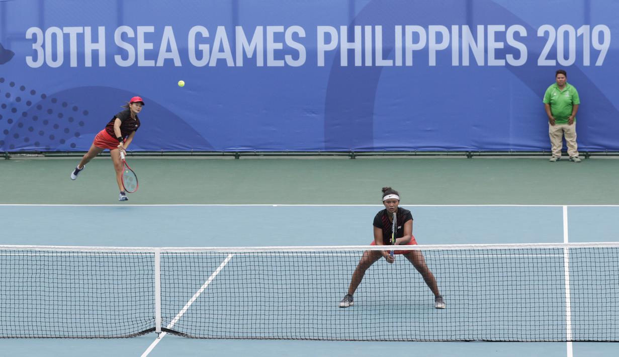 Ganda Indonesia, Priska Nugroho / Rifanty Kahfiani, saat melawan Peangtarin Plipuech / Tamarine Tanasugarn pada SEA Games 2019 di Kompleks Rizal Memorial, Kamis (5/12). Ganda Indonesia kalah 4-6, 7-6 dan 5-10. (Bola.com/M Iqbal Ichsan)
