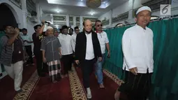 Penyidik KPK, Novel Baswedan (jas hitam) jelang melaksanakan salat berjamaah di sekitar kediaman di kawasan Kelapa Gading, Jakarta, Kamis (22/2). Novel kembali dalam proses pemulihan sambil menunggu operasi tahap kedua. (Liputan6.com/Helmi Fithriansyah)