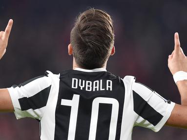 Pemain Juventus, Paulo Dybala merayakan gol ke gawang AC Milan pada laga Serie A di Allianz Stadium, Turin, (31/3/2018). Juventus menang 3-1. (Alessandro Di Marco/ANSA via AP)