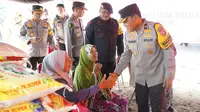 Wakil Kapolda Riau Brigjen Kasihan Rahmadi menyalami korban bencana banjir sebelum menyalurkan bantuan. (Liputan6.com/M Syukur)