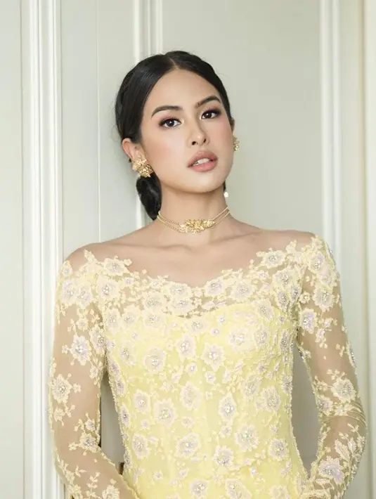 Penambahan kalung, anting, dan hiasan rambut emas menambah kesan glamor.