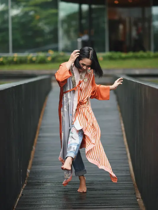 Untuk yang satu ini, Andien juga terlihat begitu cheerful dengan outer garis-garis warna oranye. Lalu ia padukan dengan celakan jeans yang membuatnya makin kece. (Instagram/andienaisyah)