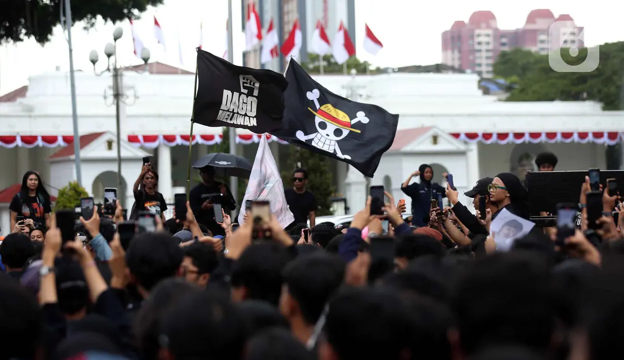 Peserta aksi Jaringan Solidaritas Korban untuk Keadilan mengibarkan bendera anime One Piece saat mengikuti peringatan 19 tahun Aksi Kamisan di Jalan Medan Merdeka Utara atau di seberang Istana Merdeka, Jakarta, 15 Januari 2026. (Liputan6.com/Helmi Fithriansyah)
