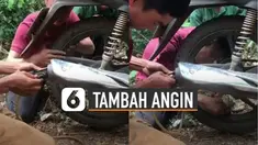 Cara unik ditunjukkan oleh beberapa lelaki ini ketika memanfaatkan knalpot motor untuk menambah angin ban.