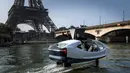 Pendiri Sea Bubbles Alain Thebault (kiri) dan Anders Bringdal (kanan) berdiri di atas kapal "flying taxi" Sea Bubble saat demonstrasi di sungai Seine di Paris, Prancis (20/5). (AFP Photo/Lionel Bonaventure)