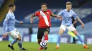 Pemain Manchester City Phil Foden (kiri) mencoba menghalau pemain Southampton Ryan Bertrand pada pertandingan Liga Inggris di Etihad Stadium, Manchester, Inggris, Rabu (10/3/2021). Manchester City menang 5-2. (Clive Brunskill/Pool via AP)