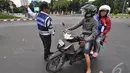 Petugas Dinas Perhubungan DKI Jakarta saat menunjukkan arah kepada seorang pengendara sepeda motor untuk tidak melewati Jl Merdeka Barat,  Jakarta, Kamis (1/1/2015). ( Liputan6.com/Miftahul Hayat)