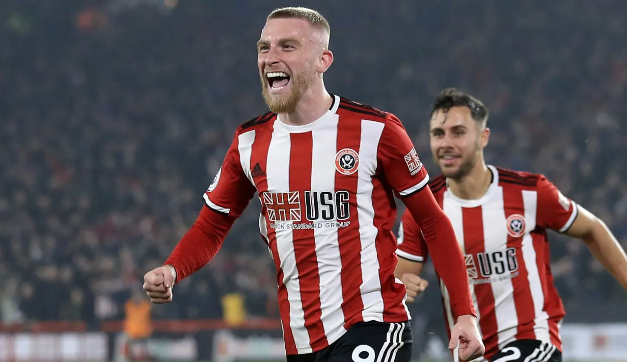 Penyerang Sheffield United, Oliver McBurnie berselebrasi usai mencetak gol ke gawang Manchester United pada pertandingan lanjutan Liga Inggris di Stadion Bramall Lane (24/11/2019). MU bermain imbang 3-3 atas Sheffield Unite. (AP Photo/Jon Super)