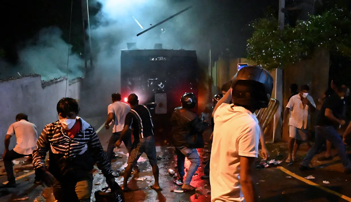 Orang-orang bentrok dengan polisi anti huru hara saat berdemonstrasi di luar rumah presiden Sri Lanka menuntut pengunduran dirinya di tengah krisis ekonomi di Kolombo (31/3/2022). Diesel tidak lagi dijual di seluruh Sri Lanka pada 31 Maret 2022. (AFP/Ishara S. Kodikara)