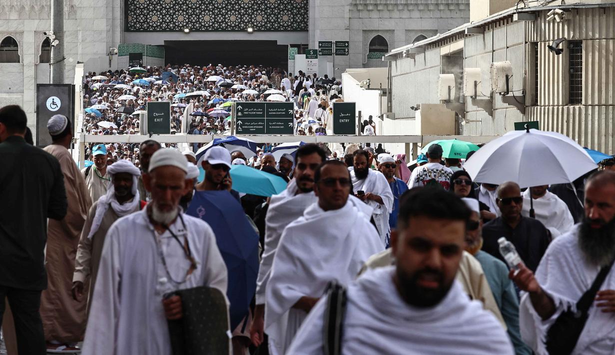 Para jamaah Muslim meninggalkan kompleks Masjidil Haram setelah menunaikan salat di kota suci Mekah pada Minggu 24 Mei 2026, menjelang ibadah haji tahunan. (Zain JAAFAR/AFP)