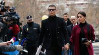 Pemain Juventus Cristiano Ronaldo menggandeng kekasihnya Georgina Rodriguez saat tiba di pengadilan di Kota Madrid, Spanyol, Selasa (22/1). Ronaldo mengikuti sidang dugaan penggelapan pajak. (AP Photo/Manu Fernandez)