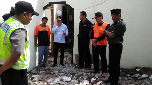 Wakil Bupati Cilacap, Syamsul Aulia Rachman dan Kepala BPBD Cilacap mengunjungi korban gempa Jawa, Kuswanto di Desa Penggalang Kecamatan Adipala, Cilacap, sekaligus menyerahkan bantuan. (Foto: Liputan6.com/Muhamad Ridlo)