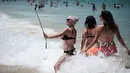 Pengunjung mengabadikan gambar dipinggir pantai Bondi Sydney selama gelombang panas yang melanda wilayah Australia, (20/11/2015). Badan Meteorologi Australia mencatat suhu mencapai lebih dari 40 derajat celsius dan akan meningkat. (REUTERS/Jason Reed)