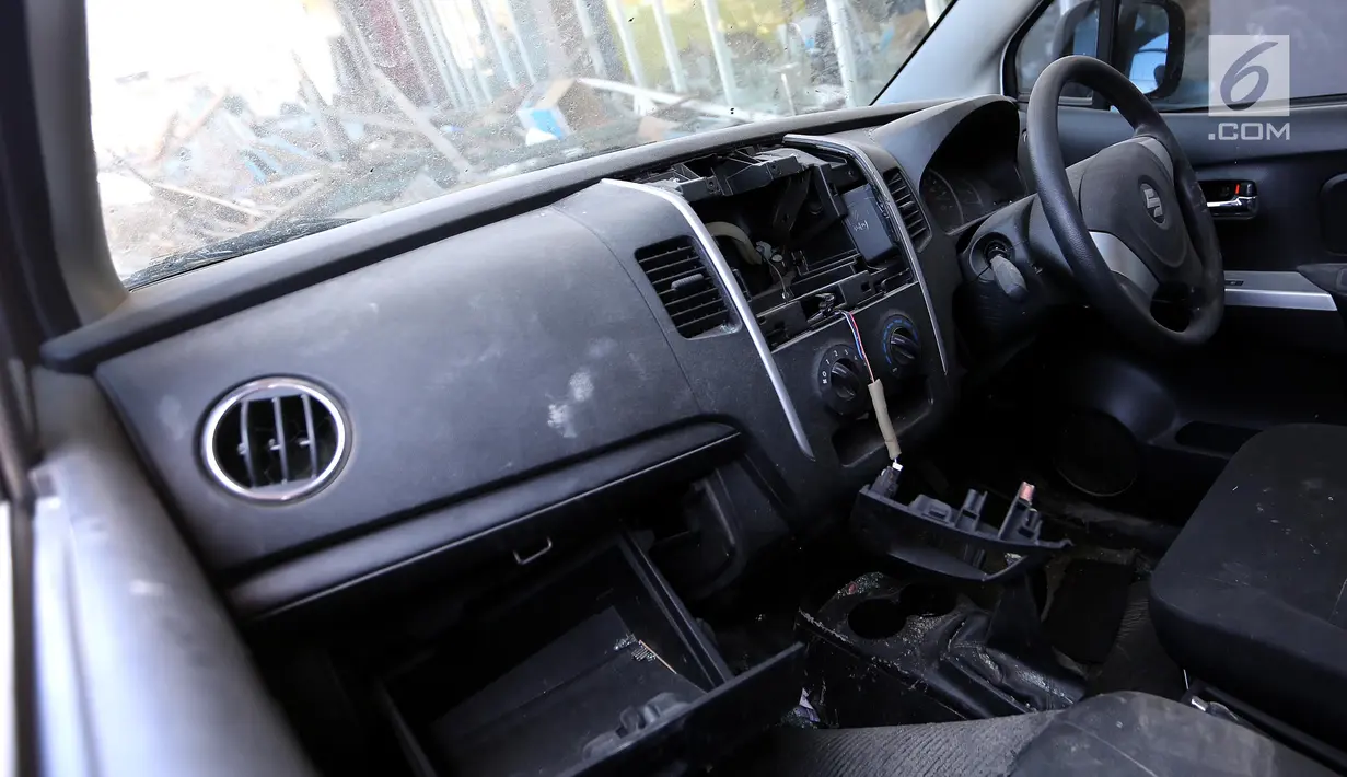 Interior pada tape mobil Suzuki yang hilang menjadi incaran jarahan korban gempa dan tsunami di Palu Grand Mal, Palu, Jumat (5/10). Warga korban gempa bumi mengambil ban dan interior mobil. (Liputan6.com/Fery Pradolo)
