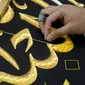 Seorang pekerja menyulam kaligrafi Islam menggunakan benang perak murni atau benang perak berlapis emas pada tahap akhir pembuatan Kiswah Kabah di Mekah, Arab Saudi, 6 Juli 2022. Jemaah haji berkumpul di Kota Suci Mekah untuk haji terbesar sejak pandemi virus corona COVID-19. (AP Photo/Amr Nabil)