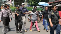 Petugas BNN dan aparat kepolisian mengamankan Warga Negara Asing (WNA) yang terkena razia di kawasan Petamburan, Jakarta, Jumat (29/1). Diduga razia tersebut terkait kasus penggerebekan sabu ratusan kilogram di Jepara. (Liputan6.com/Herman Zakharia)