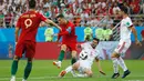 Pemain Portugal, Cristiano Ronaldo melepaskan tembakan melewati adangan pemain Iran, Saeid Ezatolahi pada laga grup B Piala Dunia 2018 di Mordovia Arena, Saransk, Rusia, (25/6/2018). Portugal dan Iran bermain imbang 1-1. (AFP/ Jack Guez)