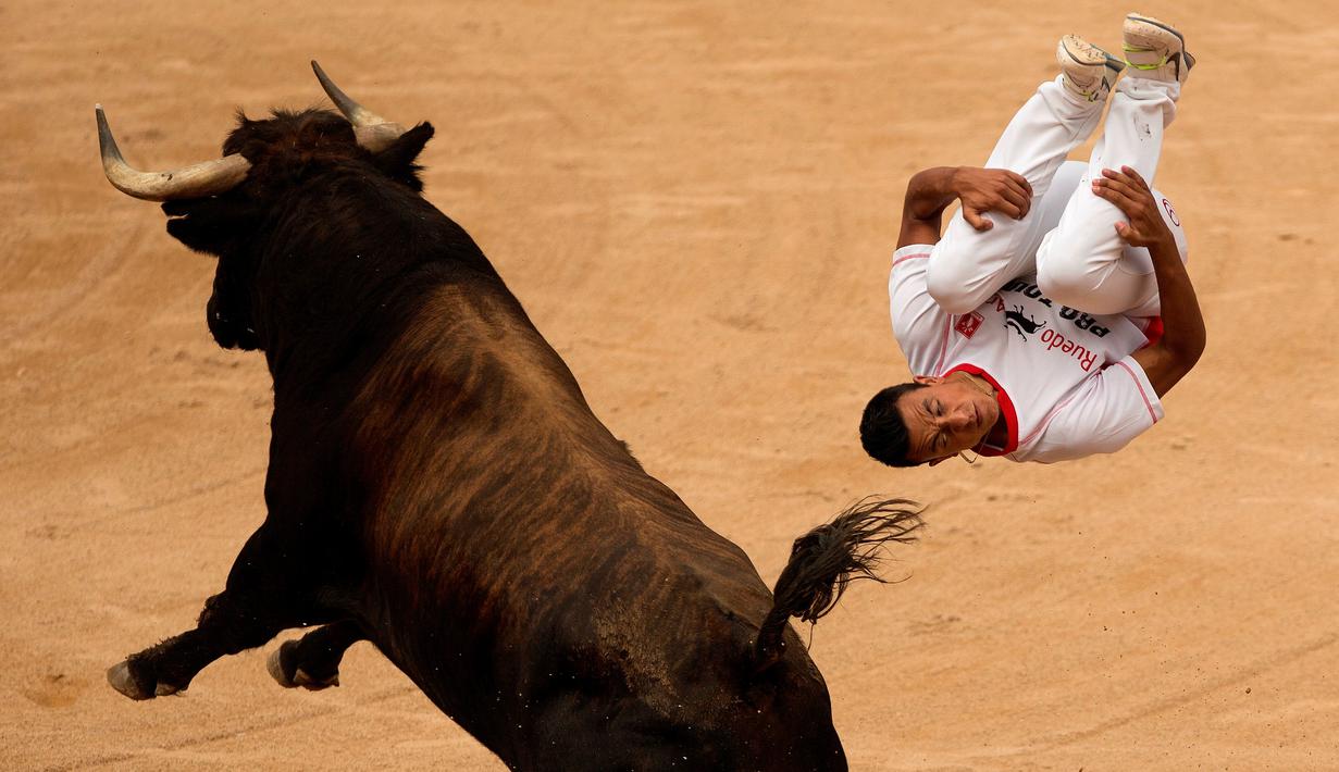 Seorang peserta melompat melewati seekor banteng dalam Festival San Fermin di Pamplona, Spanyol, (11/7/2015). (AP Photo/Andres Kudacki)