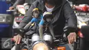 Dua ekor monyet lengkap mengenakan pakaian dan helm diatas motor yang kendarai pemiliknya terlihat di kawasan Senayan, Jakarta, Kamis (1/12). Monyet Ekor Panjang atau Monyet Pantai ini memang menjadi hewan peliharaan exotis. (Liputan6.com/Helmi Affandi)