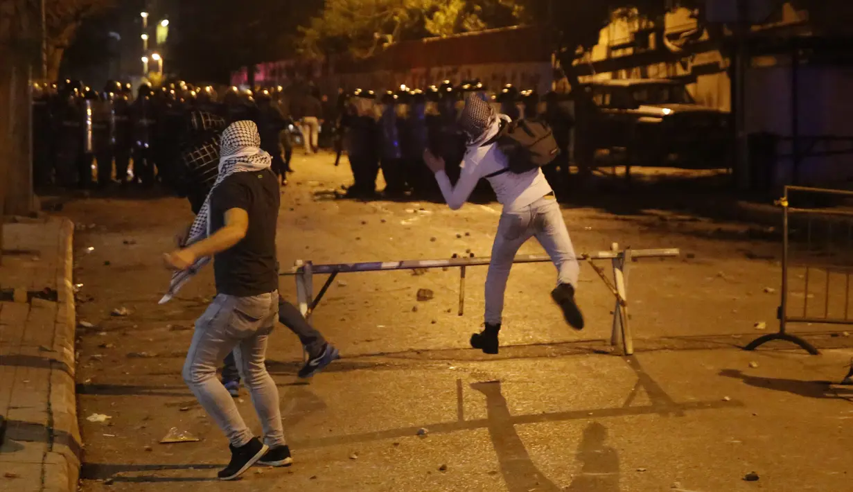 Demonstran antipemerintah bentrok dengan polisi antihuru-hara saat protes menentang elite penguasa di Beirut, Lebanon, Selasa (14/1/2020). Demonstran menganggap elite penguasa gagal mengatasi ekonomi yang menurun tajam. (AP Photo/Hussein Malla)
