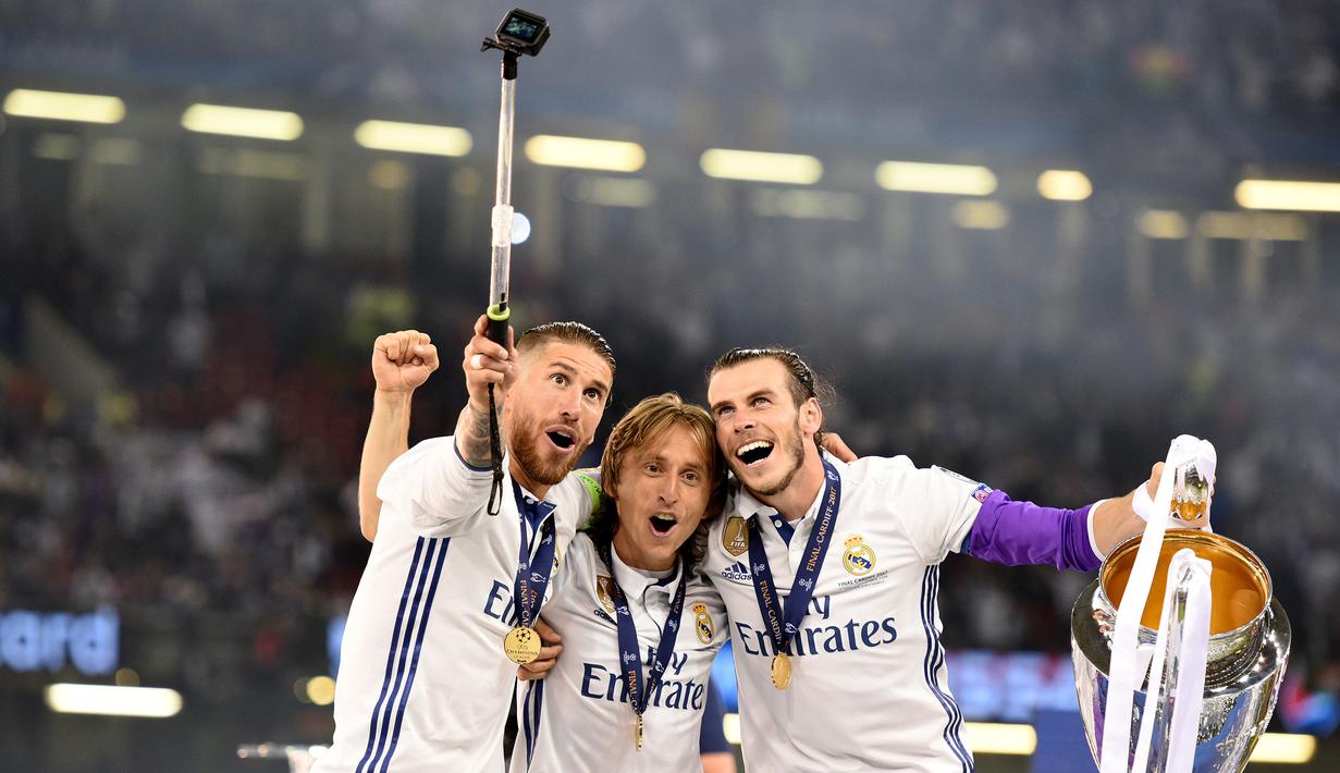 Kapten Real Madrid, Sergio Ramos, bersama Modric dan Bale foto bersama setelah memenangkan final Liga Champions dengan mengalahkan Juventus 4-1 di Stadion Millennium, Cardiff, (03/06/2017). (EPA/Peter Powell)