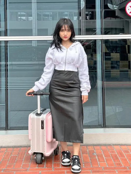 <p>Fuji an memadukan midi skirt leather hitam dengan jaket crop top warna putih dan sneakersnya. [@fuji_an]</p>