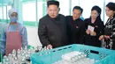 Pemimpin Korea Utara, Kim Jong-Un ditemani istrinya, Ri Sol-Ju (kanan) memeriksa produk kosmetik di sebuah pabrik di Pyongyang pada gambar tak bertanggal yang dirilis kantor berita KCNA pada 29 Oktober 2017. (AFP PHOTO / KCNA VIA KNS / STR)