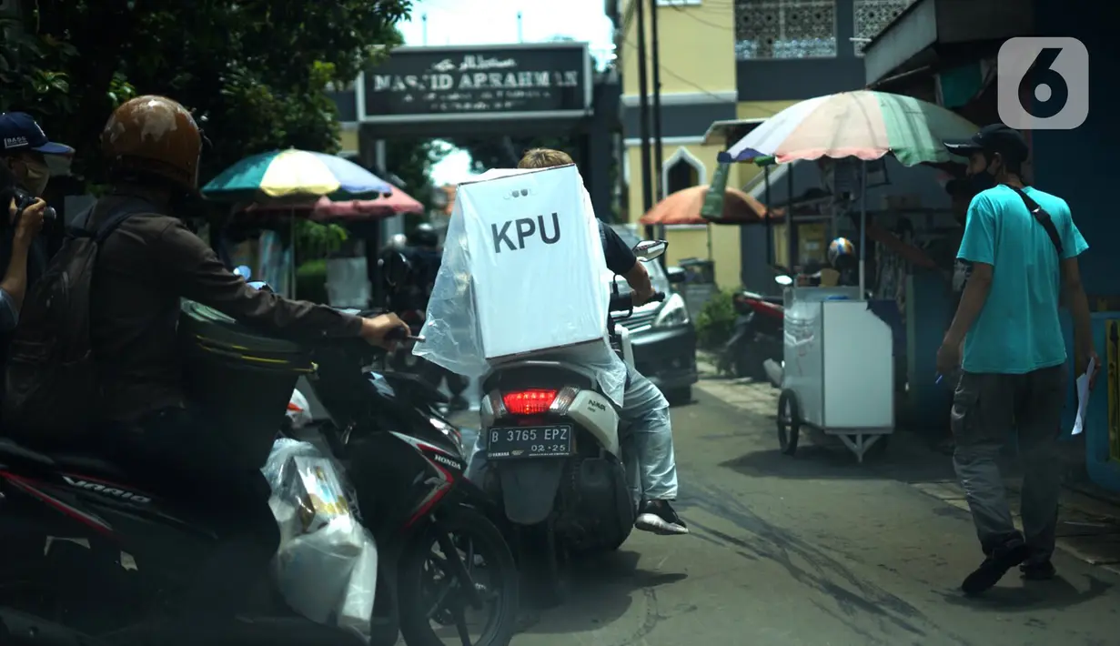 Petugas membawa logistik kotak suara Pilkada Depok 2020 untuk didistribusikan di sejumlah RW Kecamatan Beji, Depok, Selasa (8/12/2020). Total, ada 4.049 kotak suara yang sedang didistribusikan ke TPS setempat dan di dalamnya terdapat 1.262.051 lembar surat suara. (Liputan6.com/Immanuel Antonius)