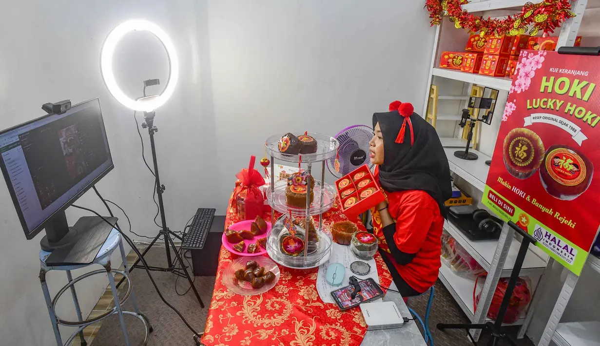 Meski belum dapat dipastikan berapa kenaikan omzet pada tahun ini, namun penjualan secara online terus ditingkatkan. Tampak dalam foto, pekerja melakukan penjualan kue keranjang secara daring/online di Pabrik Kue Hoki, kawasan Sawangan, Depok, Jawa Barat, Rabu (11/2/2025). (merdeka.com/Arie Basuki)