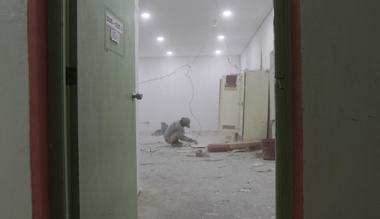 Pekerja menyelesaikan proyek ruang ganti di Stadion Rizal Memorial, Manila, Senin (25/11). Meski akan digunakan besok untuk cabang sepak bola SEA Games 2019 namun kondisinya masih belum layak. (Bola.com/M Iqbal Ichsan)