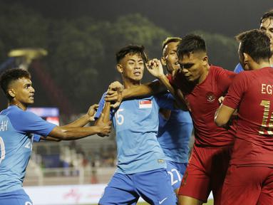Pemain Timnas Indonesia U-22, Rachmad Irianto, melerai Egy Maulana, saat bersitegang dengan pemain Singapura U-22 pada laga SEA Games 2019 di Stadion Rizal Memorial, Manila, Kamis (28/11). Indonesia menang 2-0 atas Singapura. (Bola.com/M Iqbal Ichsan)