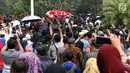 Warga berdesakan melihat prosesi pemakaman Presiden ke-3 RI BJ Habibie di TMP Kalibata, Jakarta, Kamis (12/9/2019). Sejumlah petinggi negara menghadiri pemakaman Habibie. (Liputan6.com/Helmi Fithriansyah)