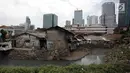 Anak-anak sekolah melintas di Kampung Kuningan Timur, Jakarta, Kamis (11/1). Permukiman warga miskin di kampung tersebut terlihat kontras dengan pembangunan hunian bertingkat mewah dan pusat-pusat perbelanjaan di sekitarnya. (Liputan6.com/Arya Manggala)