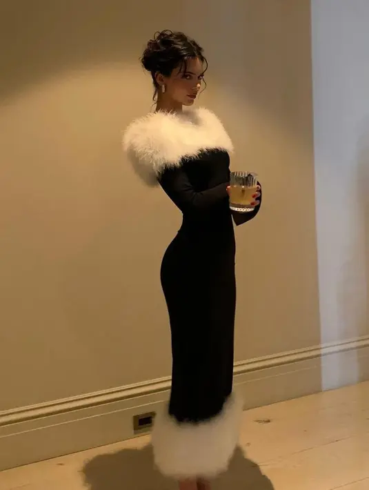 Sementara itu, Kendall mengenakan gaun dengan konsep Mrs. Claus beludru hitam lengan panjang dari 16Arlington dengan hiasan marabou putih lembut di bagian leher dan ujungnya. [@kendalljenne]