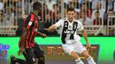 3. Cristiano Ronaldo mencoba melewati Christian Zapata pada laga Final Piala Super Italia yang berlangsung di stadion King Abdullah Sports City, Jeedah, Kamis (17/1). Juventus menang 1-0  atas AC Milan (AFP/Giuseppe Cacace)