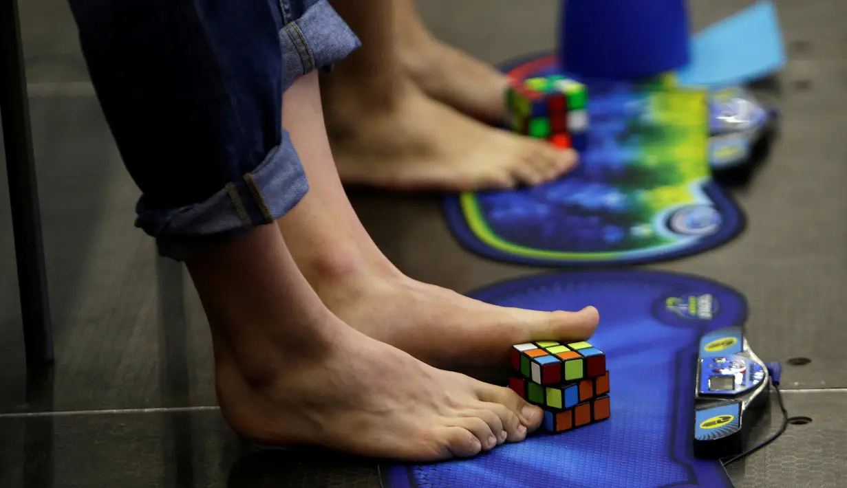 Peserta saat berlatih untuk memecahkan permainan rubik dengan kaki pada Kejuaraan Rubik Eropa  di Praha , Republik Ceko , (15/7).Salah satu kompetisi Rubik terbesar ini diikuti lebih dari 500 peserta. (REUTERS / David W Cerny)