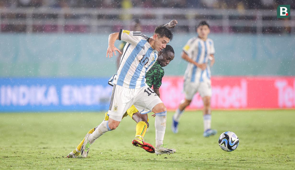 <p>Pemain Timnas Argentina U-17, Claudio Echeverri berebut bola dengan seorang pemain Timnas Mali U-17 pada laga perebutan tempat ketiga Piala Dunia U-17 2023 di Stadion Manahan, Solo, Jumat (1/12/2023). (Bola.com/Bagaskara Lazuardi)</p>