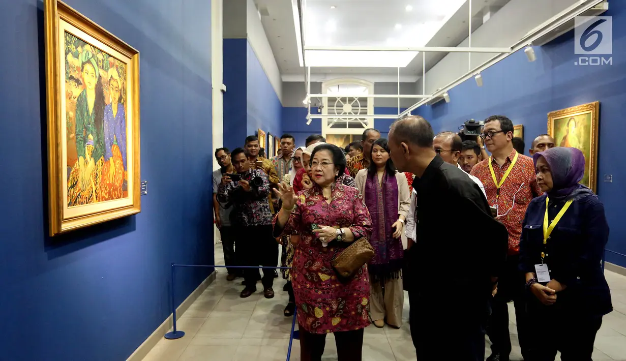 Presiden RI ke-5 Megawati Soekarnoputri mendengarkan penjelasan dari Kurator seni di Galeri Nasional, Jakarta, Kamis (10/8). Kedatangan Megawati untuk melihat pameran lukisan koleksi Istana yang bertema 'Senandung Ibu Pertiwi'. (Liputan6.com/Johan Tallo)