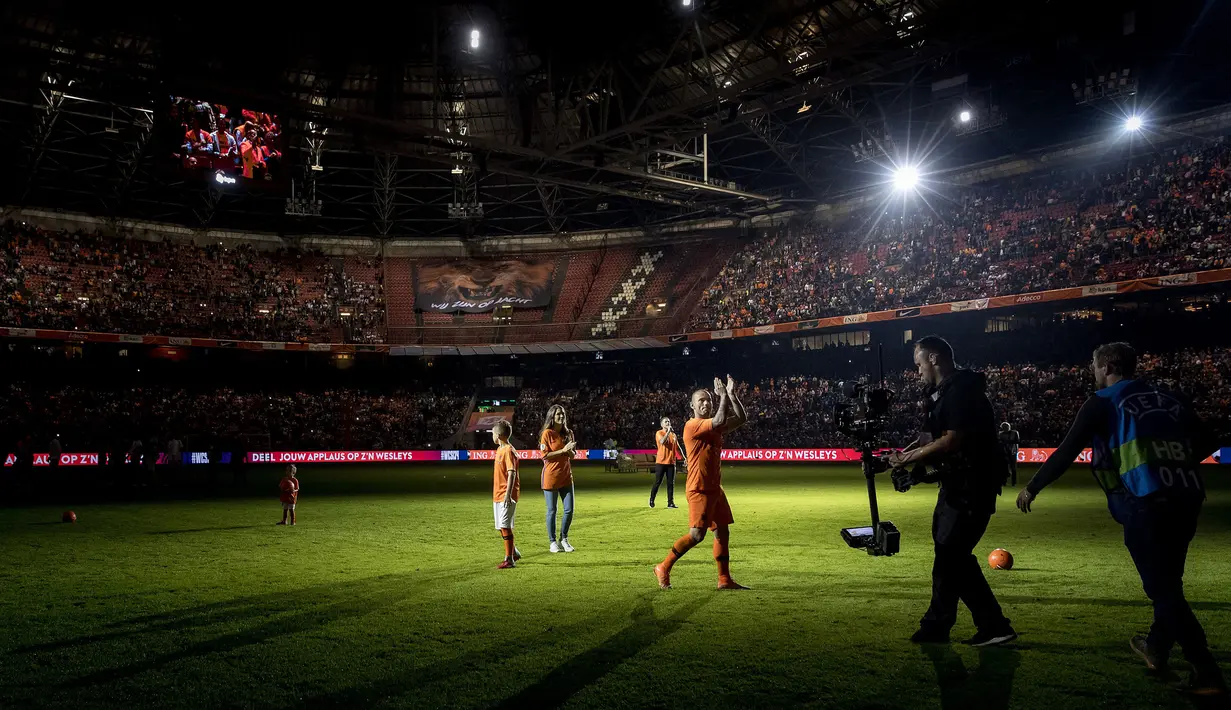 Gelandang Timnas Belanda, Wesley Sneijder menyapa para fans usai laga persahabatan melawan Peru di Amsterdam, Kamis (6/9). Sneijder merasakan perasaan yang emosional pada laga terakhirnya tersebut. (KOEN VAN WEEL/ANP/AFP)