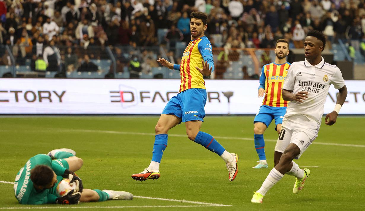 Selepas skor imbang 1-1, laga berjalan menarik dengan saling melancarkan serangan. Beberapa peluang sempat diraih kedua tim. Salah satunya adalah melalui Vinicius Junior yang masih gagal menaklukkan kiper Valencia Giorgi Mamardashvili. (AFP/Giuseppe Cacace)